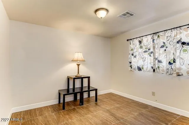 a view of a room with wooden floor and a window
