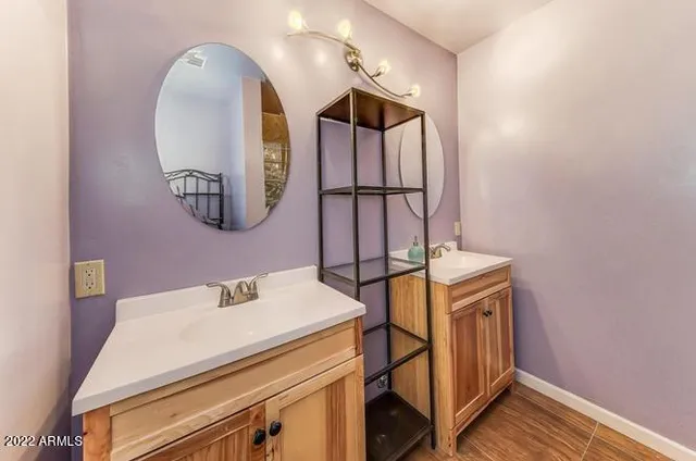 a bathroom with a sink a mirror and a shower