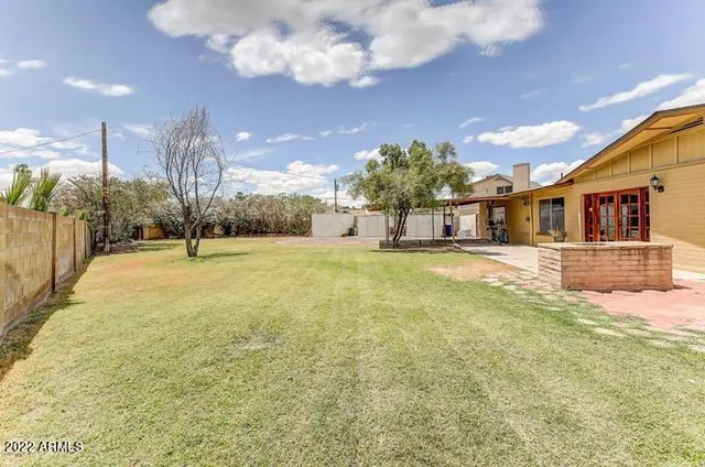 a swimming pool with outdoor seating and yard