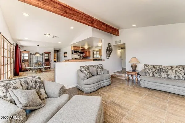 a living room with furniture and kitchen view