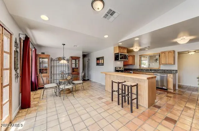 a living room with kitchen view and furniture