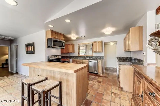 a kitchen with a stove a refrigerator and a refrigerator