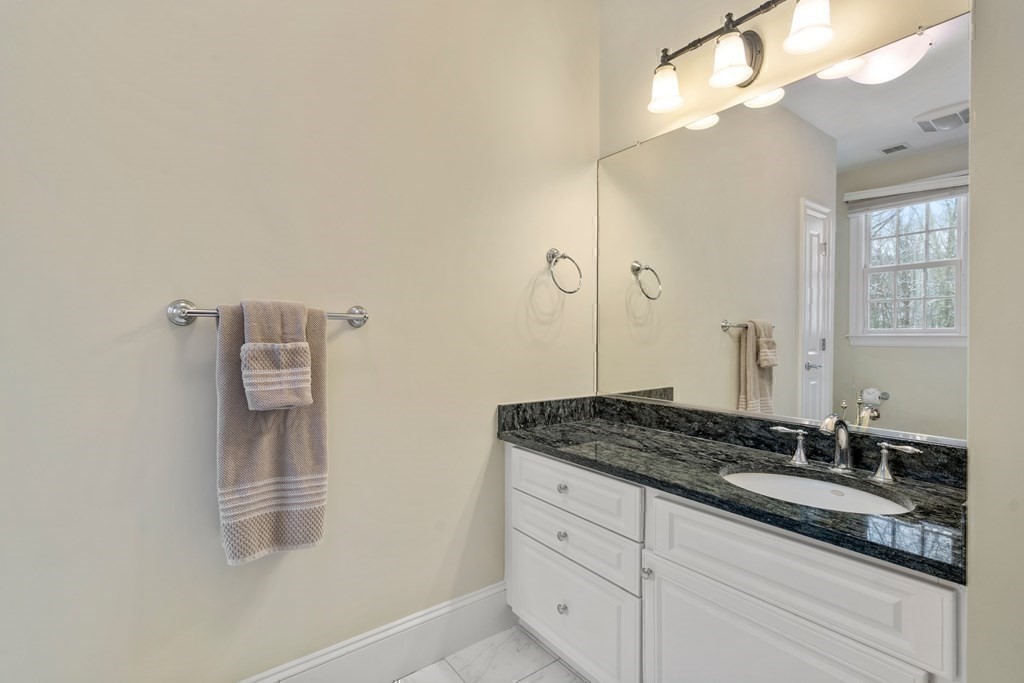 8 Stonegate Lane Dover, MA 02030 - Photo 30 of 42 a bathroom with a granite countertop sink and a mirror