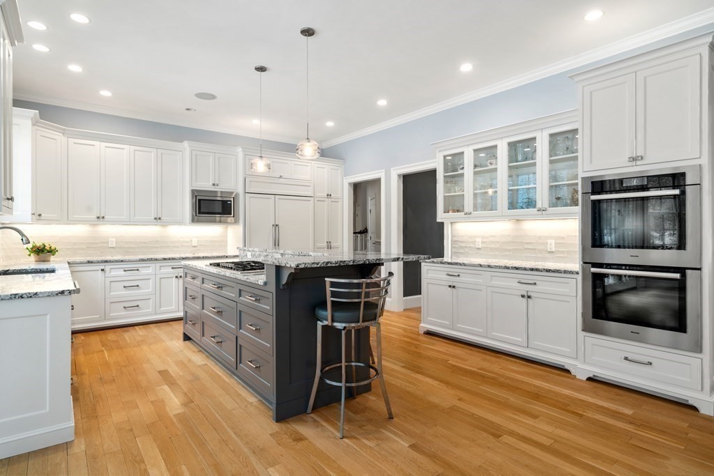 8 Stonegate Lane Dover, MA 02030 - Photo 8 of 42 a kitchen with stainless steel appliances granite countertop a stove top oven a sink dishwasher a refrigerator and a dining table with wooden floor