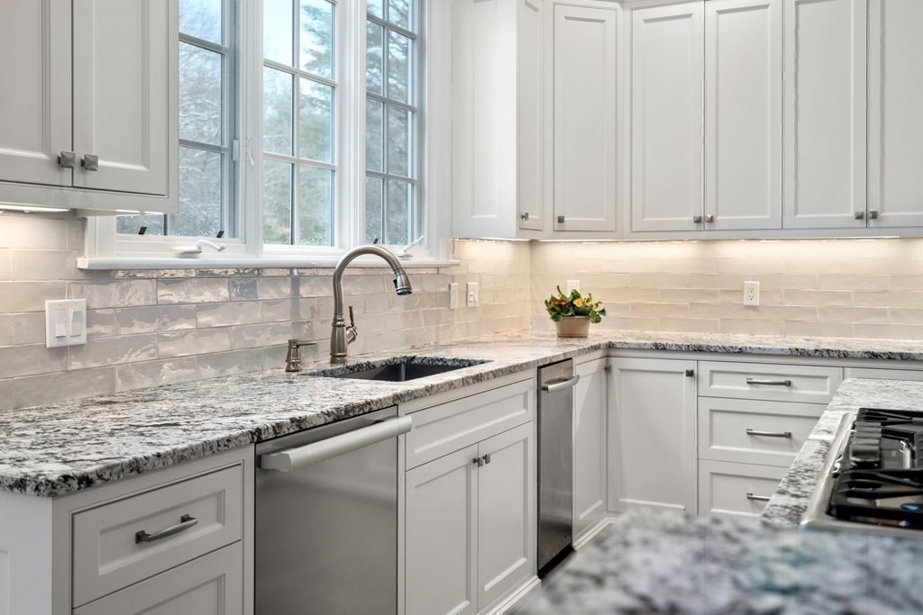 8 Stonegate Lane Dover, MA 02030 - Photo 10 of 42 a kitchen with stainless steel appliances granite countertop a sink stove and cabinets