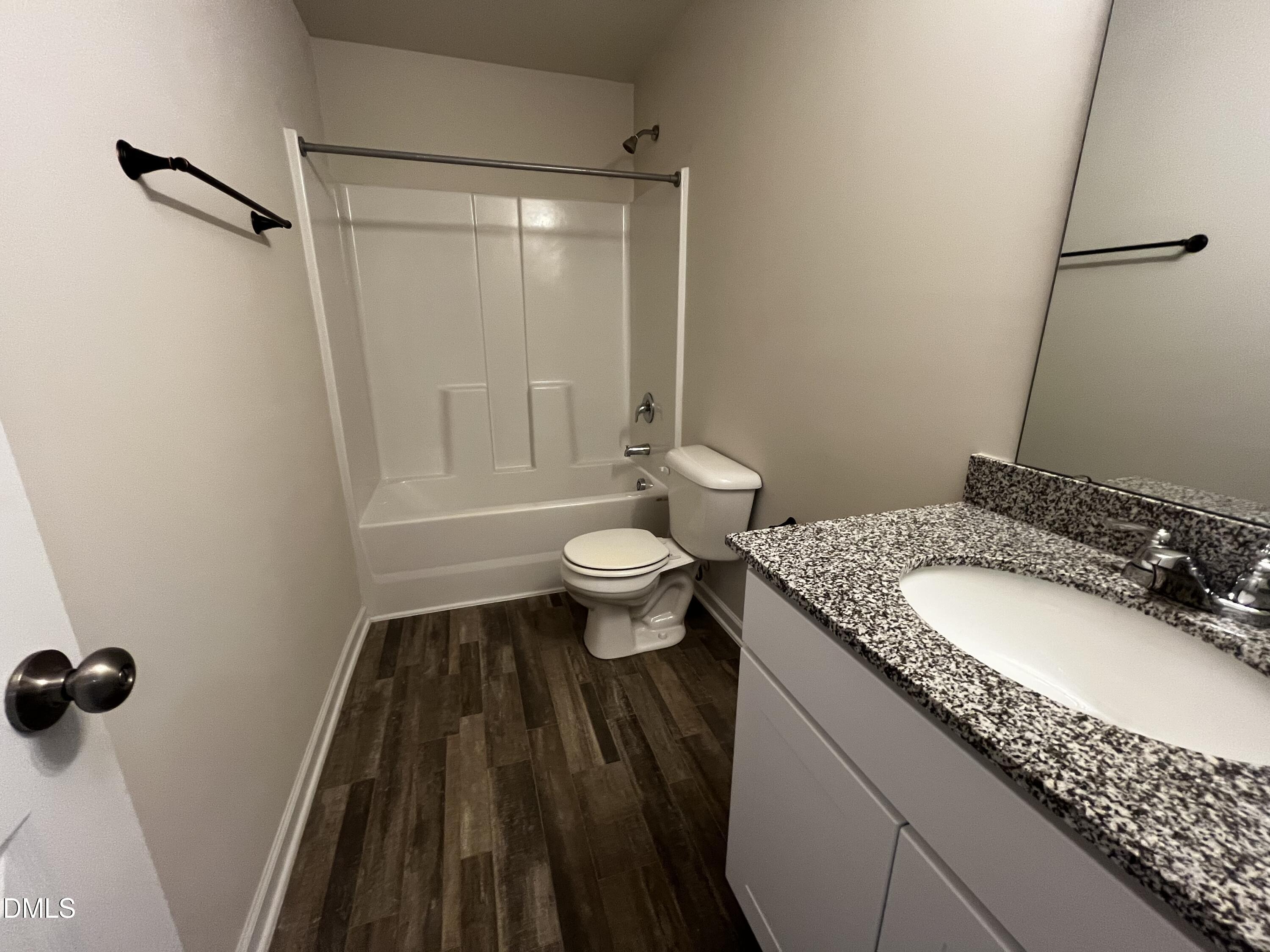 46 East Boulder Road Henderson, NC 27537 - Photo 14 of 15 a bathroom with a granite countertop sink toilet and shower