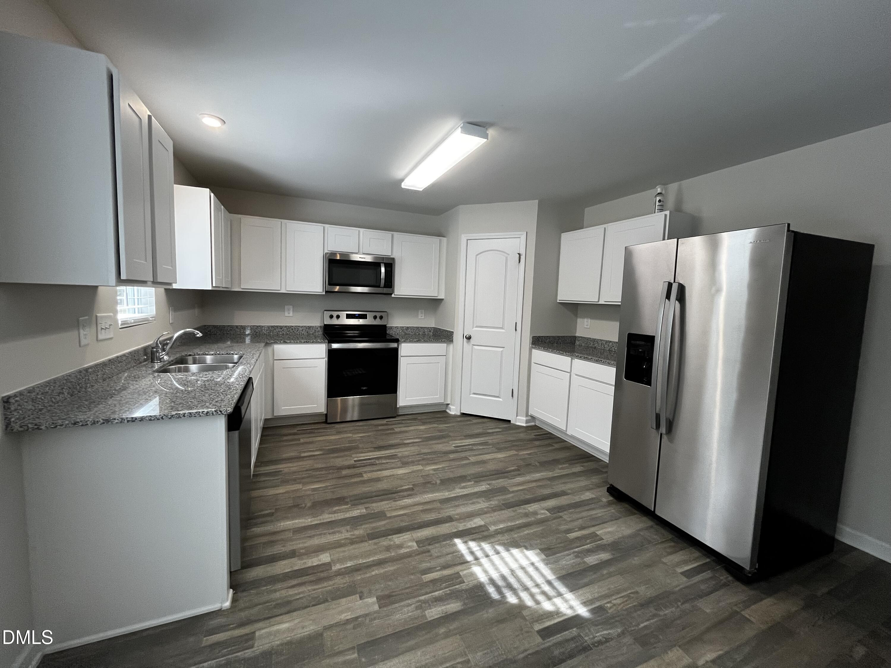 46 East Boulder Road Henderson, NC 27537 - Photo 4 of 15 a kitchen with stainless steel appliances granite countertop a refrigerator stove microwave and sink