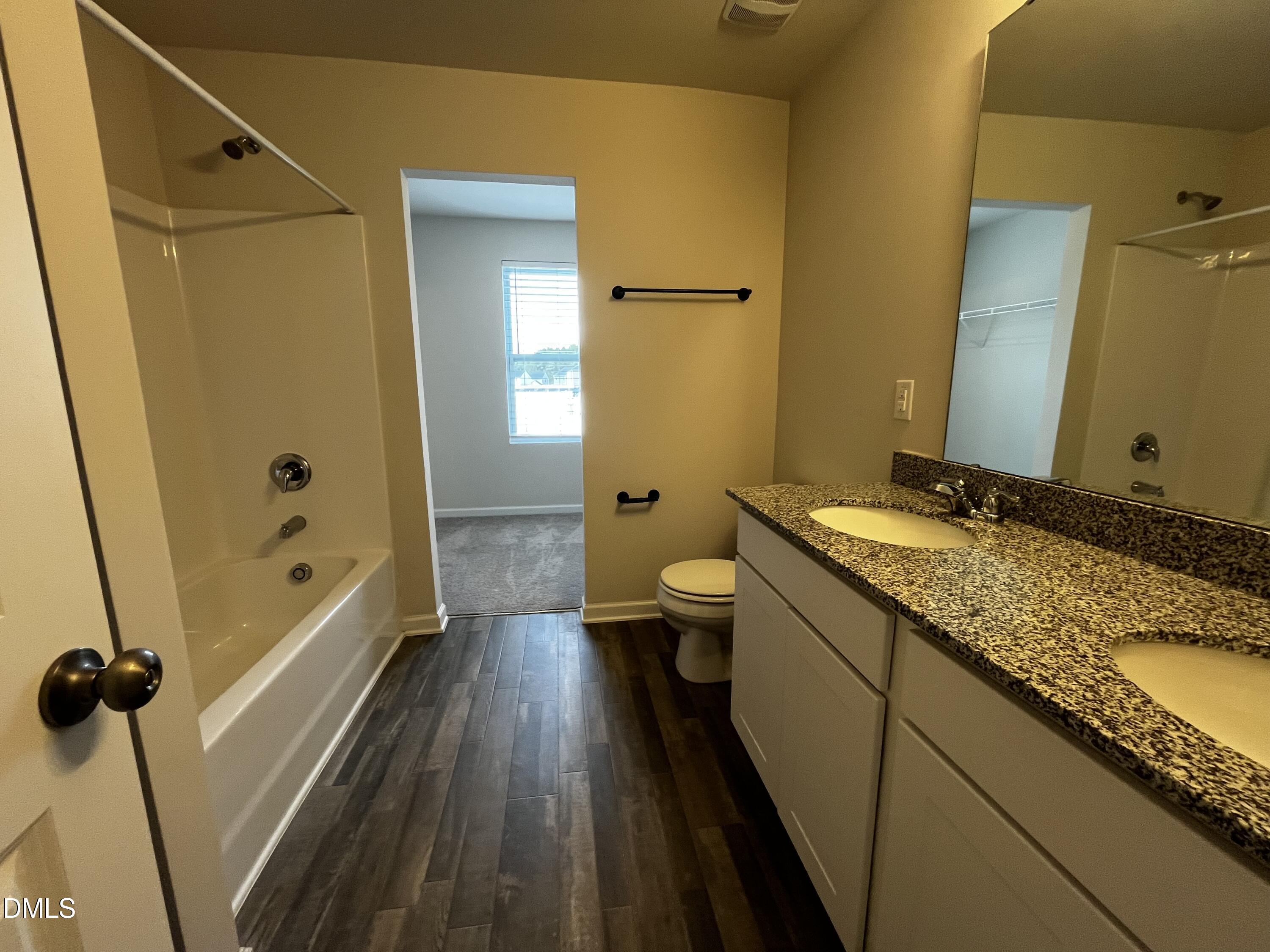 46 East Boulder Road Henderson, NC 27537 - Photo 9 of 15 a bathroom with a granite countertop sink toilet and shower