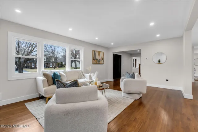 a living room with furniture and large windows