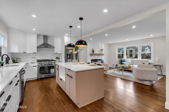 a large kitchen with stainless steel appliances kitchen island granite countertop a large center island and a sink