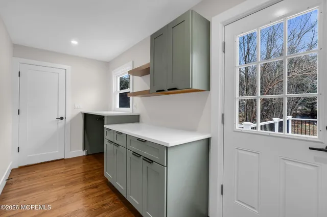 a kitchen with a cabinets and wooden floor