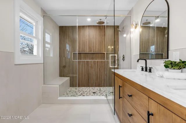 a bathroom with a sink a mirror and a shower