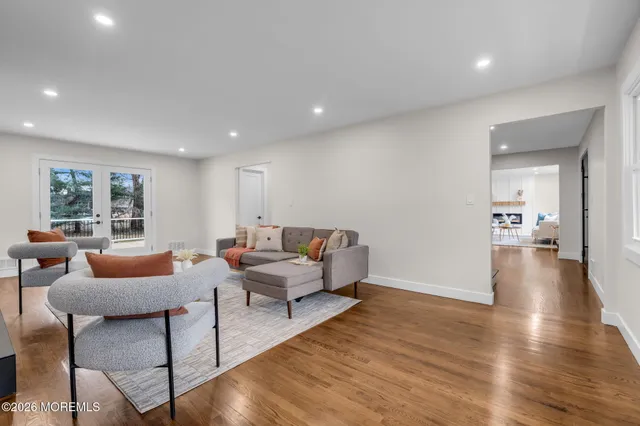 a living room with furniture and a wooden floor