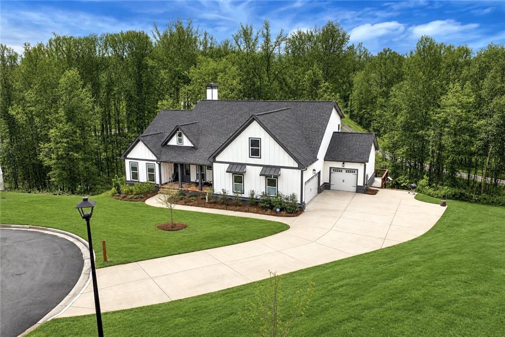 6140 Crescent Moon Ridge Cumming, GA 30041 - Photo 1 of 54 a view of house with garden and trees