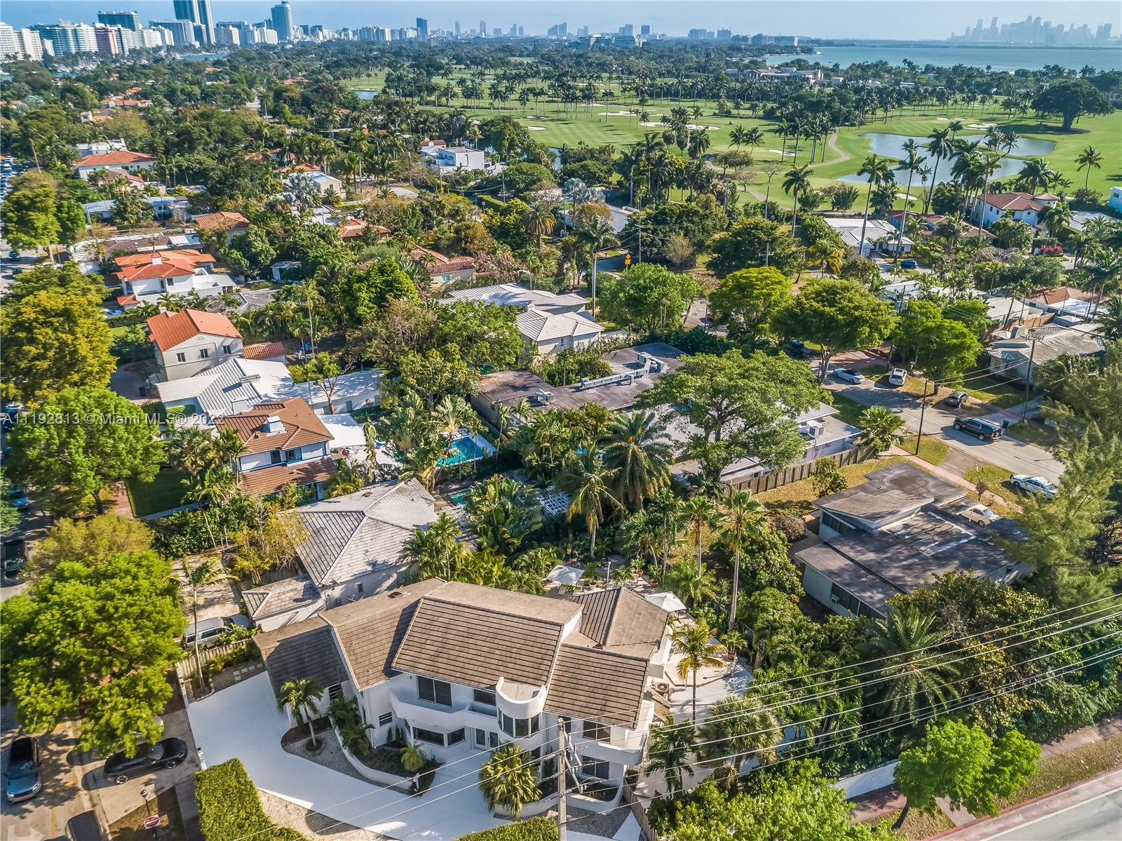 6180 Pine Tree Drive Miami Beach, FL 33140 - Photo 3 of 32 an aerial view of residential houses with outdoor space and trees