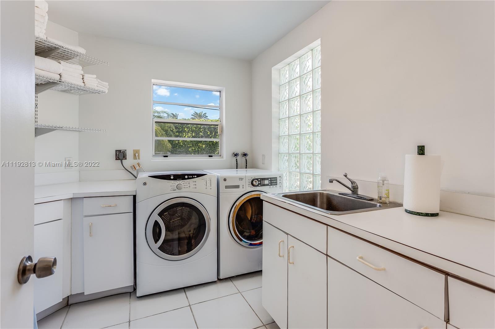 6180 Pine Tree Drive Miami Beach, FL 33140 - Photo 32 of 32 a utility room with sink dryer and washer