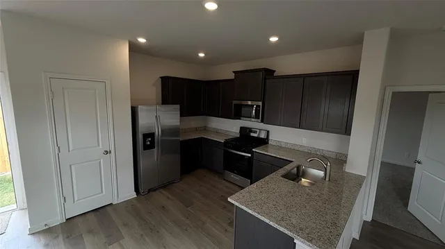 a kitchen with a refrigerator and stove