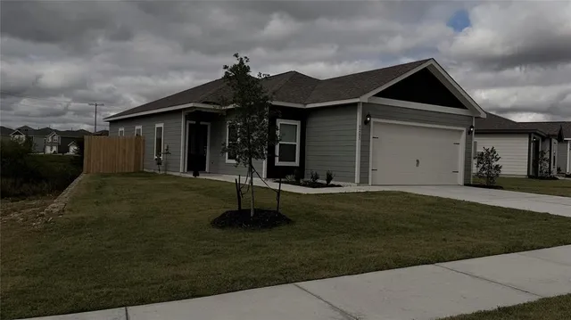 a front view of a house with a yard