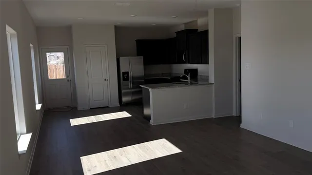 a kitchen with a refrigerator and a stove