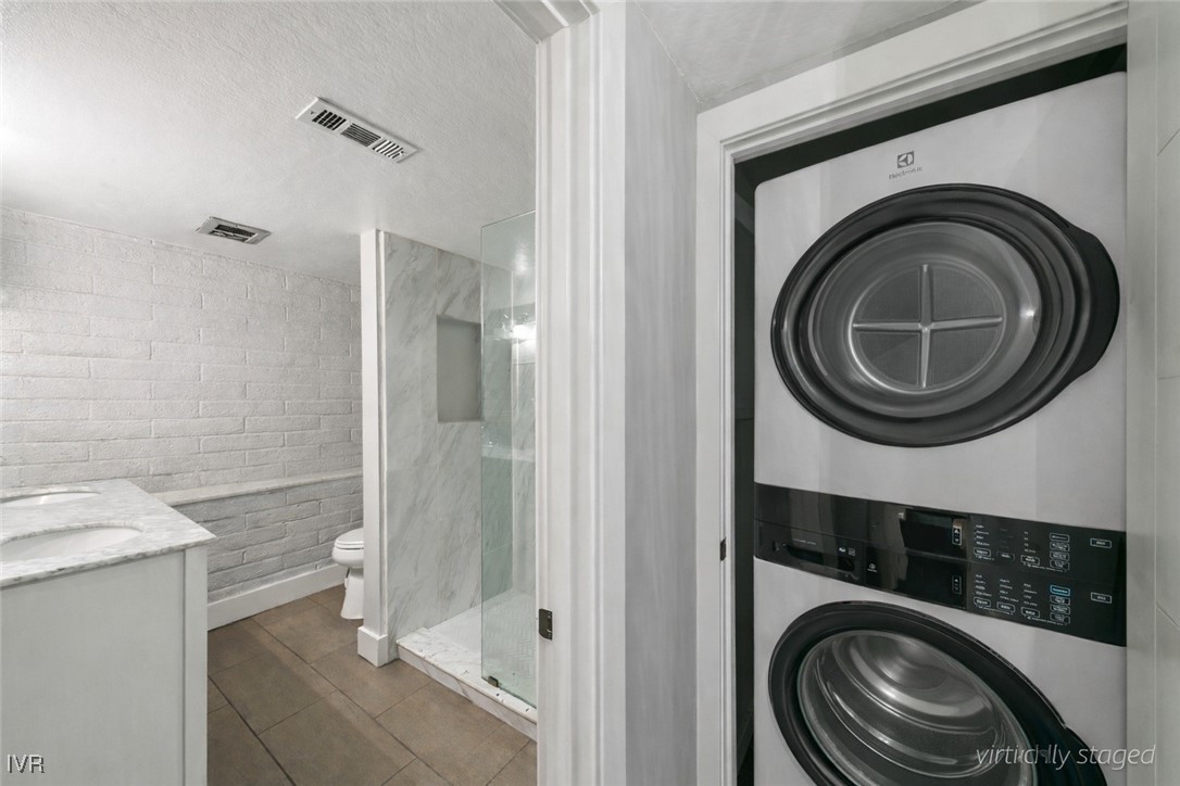 120 Country Club Drive, Unit 3 Incline Village, NV 89451 - Photo 20 of 38 a bathroom with a sink a washer and dryer