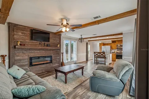 a kitchen with stainless steel appliances a microwave a stove a sink dishwasher and cabinets with wooden floor