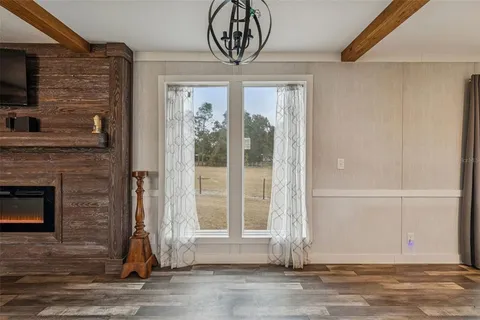 a kitchen with stainless steel appliances granite countertop a sink dishwasher a stove and a refrigerator with wooden floor