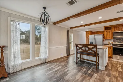 a kitchen with stainless steel appliances granite countertop a refrigerator a sink and a stove