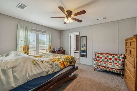 a view of swimming pool with seating space and trees in the background