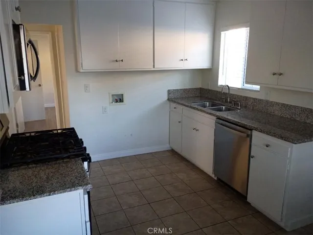 a kitchen with granite countertop a stove and a granite counter tops