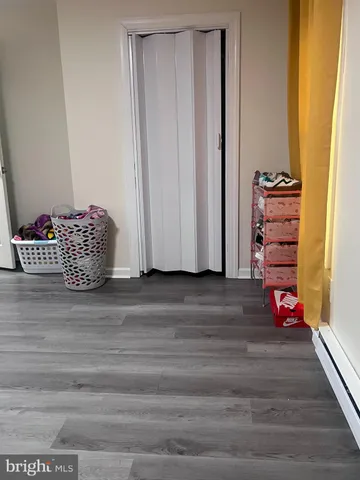 a view of room with wooden floor