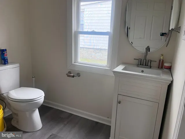 a bathroom with a sink toilet and a mirror