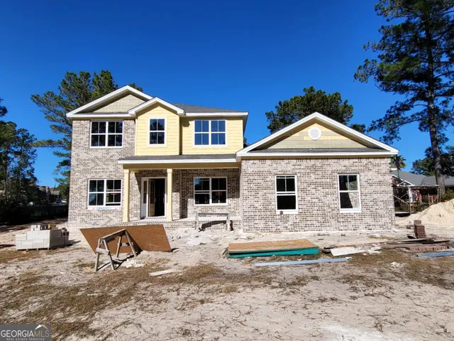 a view of a white house with a yard
