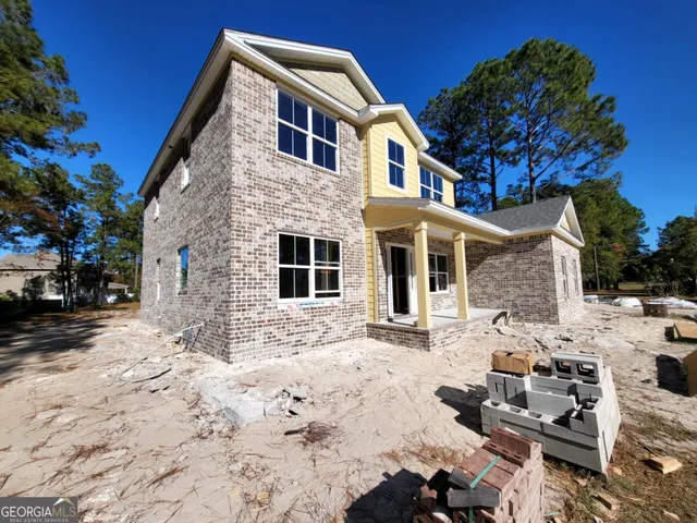 a front view of a house with a yard covered in snow