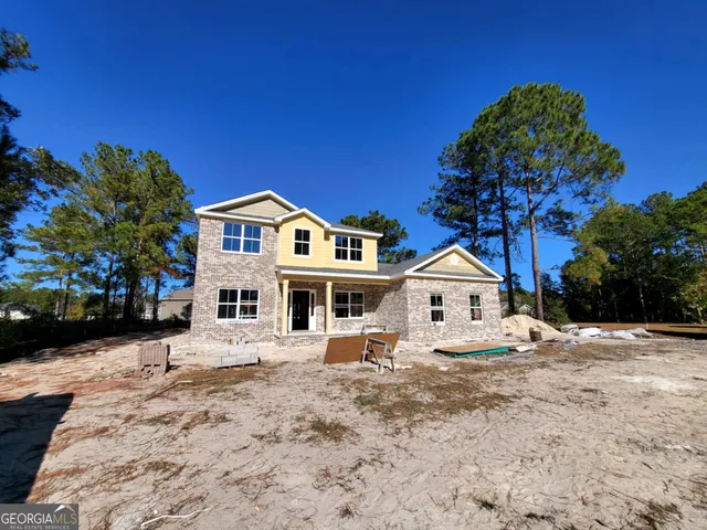 a front view of a house with a yard