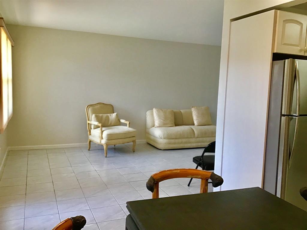 1004 Newcastle A, Unit 1004 Boca Raton, FL 33434 - Photo 13 of 39 a living room with furniture and a table