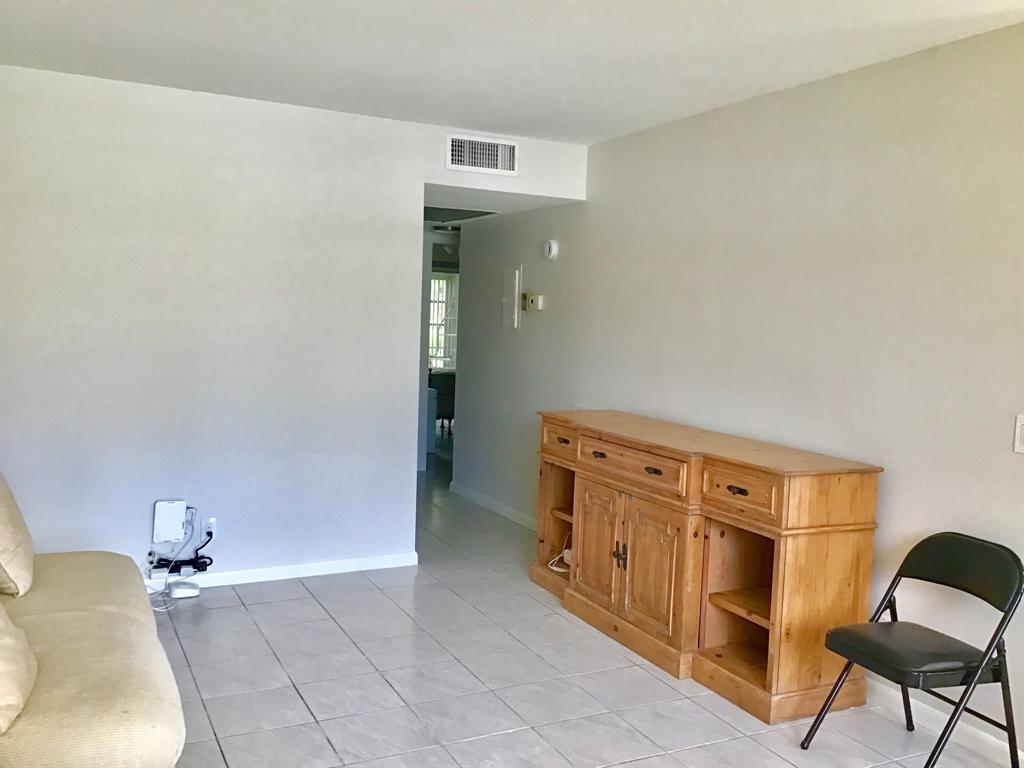 1004 Newcastle A, Unit 1004 Boca Raton, FL 33434 - Photo 17 of 39 a bedroom with a bed and cabinets