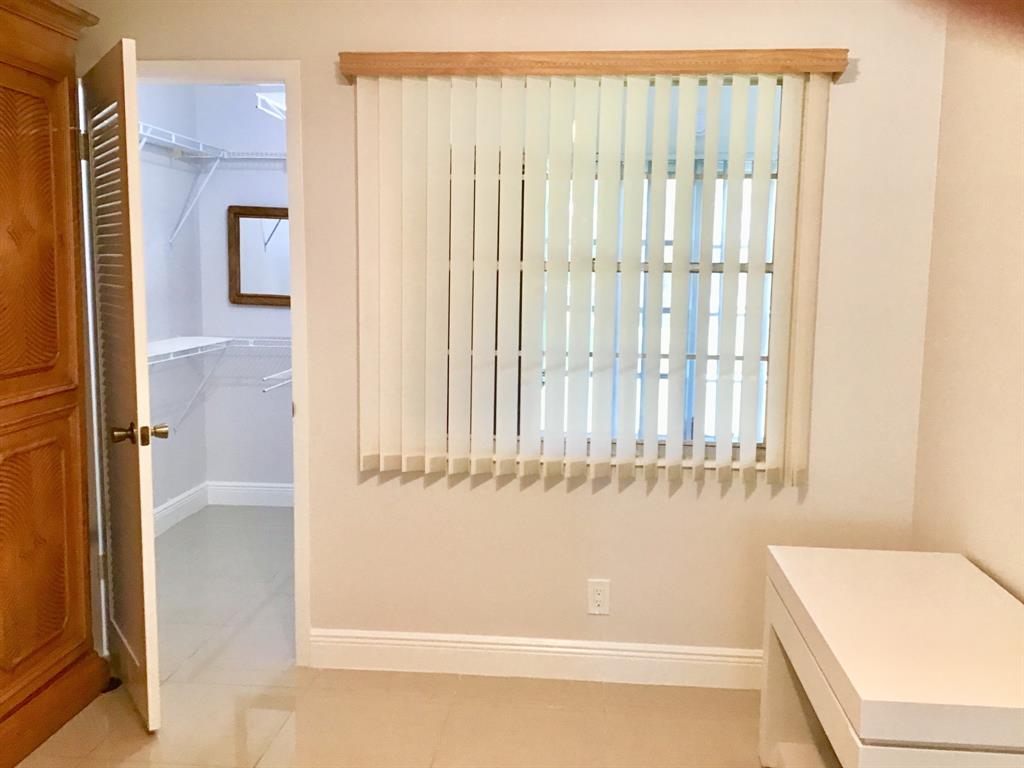 1004 Newcastle A, Unit 1004 Boca Raton, FL 33434 - Photo 19 of 39 a bathroom with a bathtub and a shower