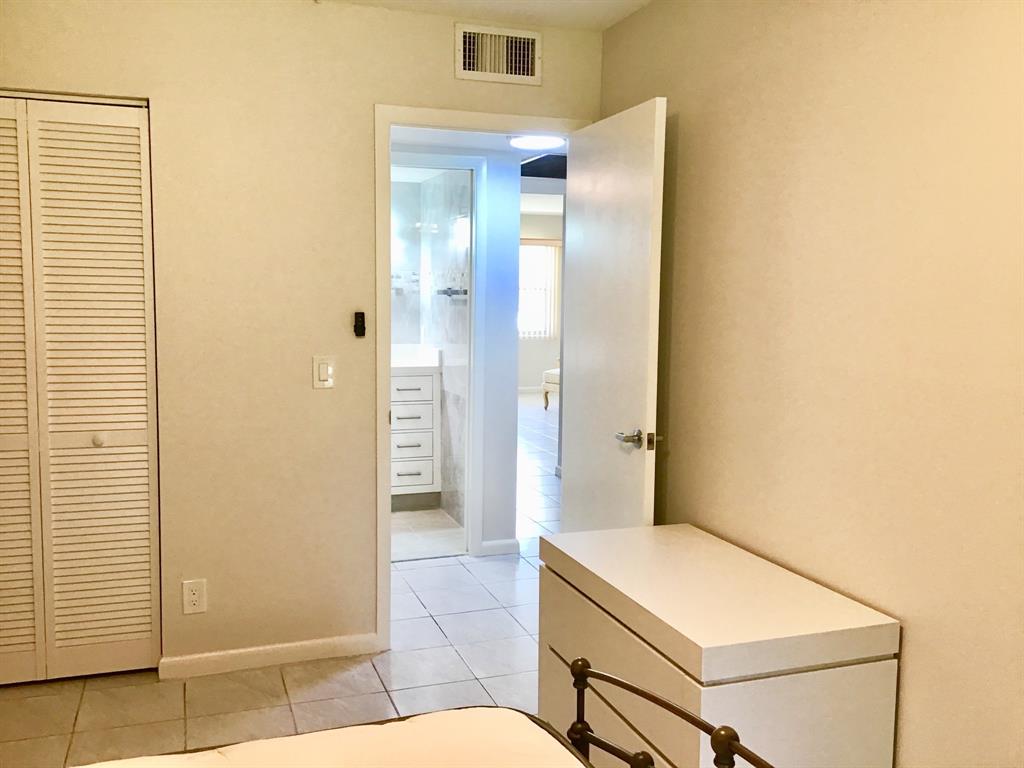 1004 Newcastle A, Unit 1004 Boca Raton, FL 33434 - Photo 22 of 39 a bathroom with a sink and a mirror