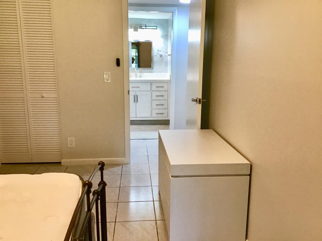 1004 Newcastle A, Unit 1004 Boca Raton, FL 33434 - Photo 24 of 39 a bathroom with a sink a toilet and shower