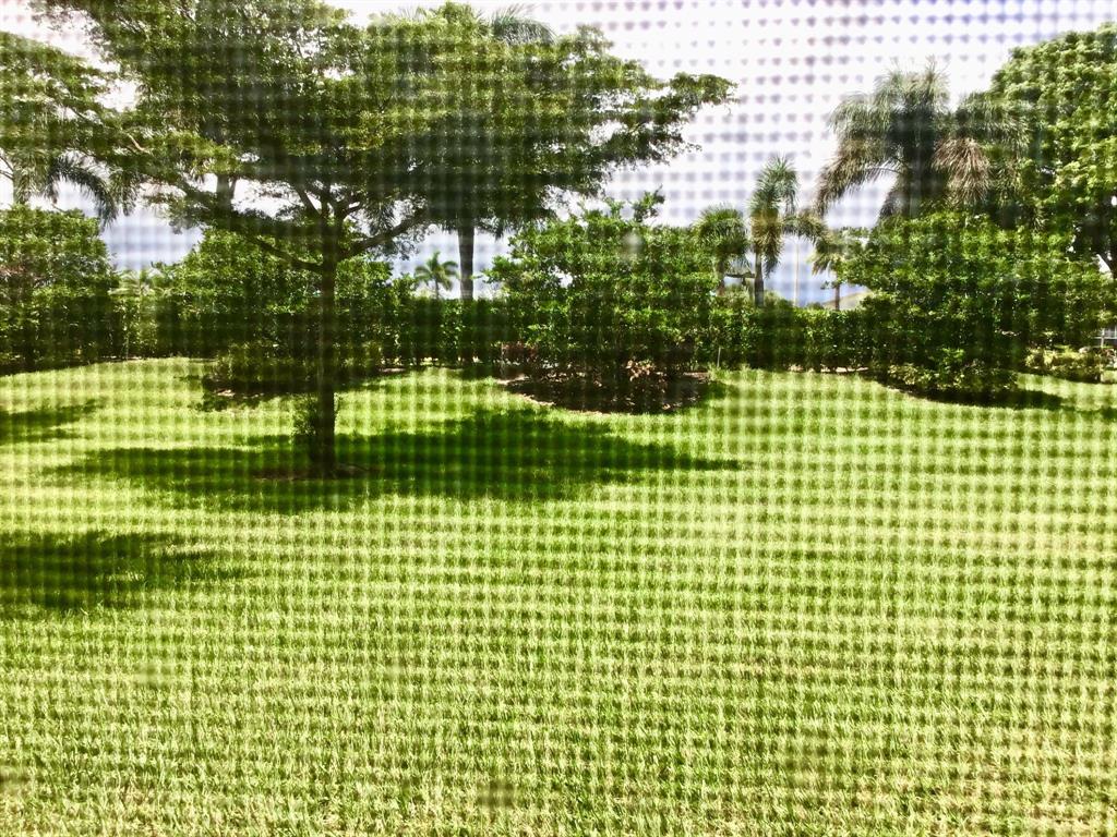 1004 Newcastle A, Unit 1004 Boca Raton, FL 33434 - Photo 30 of 39 a view of a building and large windows