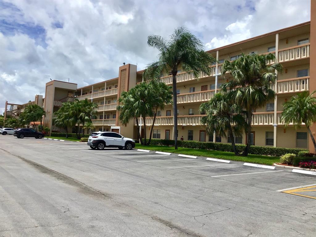 1004 Newcastle A, Unit 1004 Boca Raton, FL 33434 - Photo 32 of 39 a car parked in front of a building