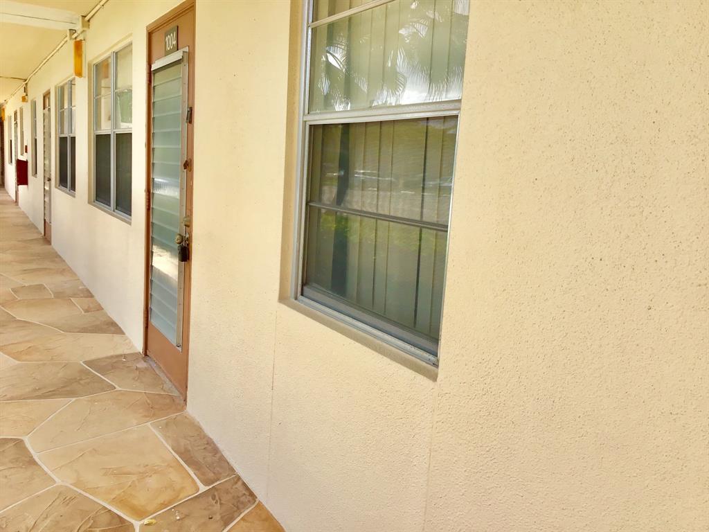 1004 Newcastle A, Unit 1004 Boca Raton, FL 33434 - Photo 34 of 39 a view of a glass door with a glass door