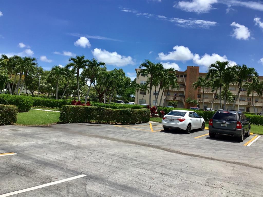 1004 Newcastle A, Unit 1004 Boca Raton, FL 33434 - Photo 36 of 39 a view of street with parked cars