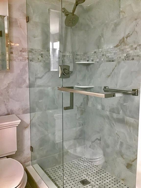 1004 Newcastle A, Unit 1004 Boca Raton, FL 33434 - Photo 4 of 39 a bathroom with a toilet and a shower