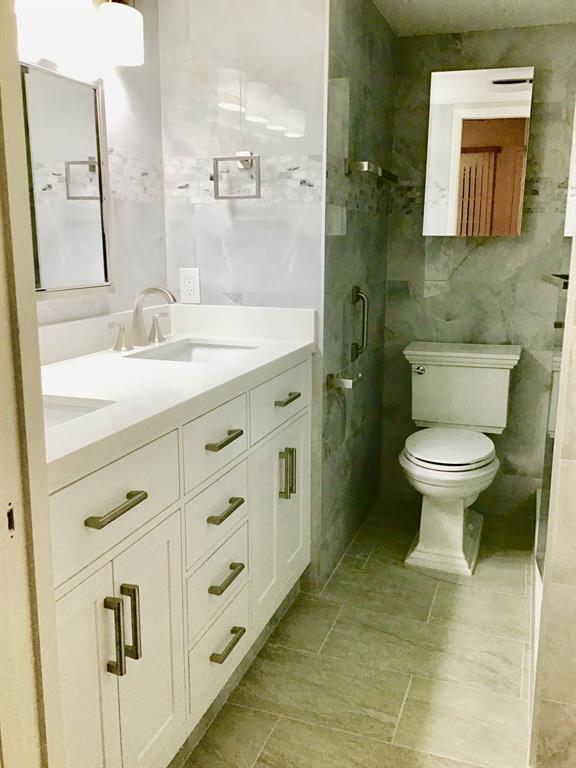 1004 Newcastle A, Unit 1004 Boca Raton, FL 33434 - Photo 5 of 39 a bathroom with a sink toilet and a mirror