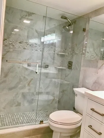 a bathroom with a toilet and a shower