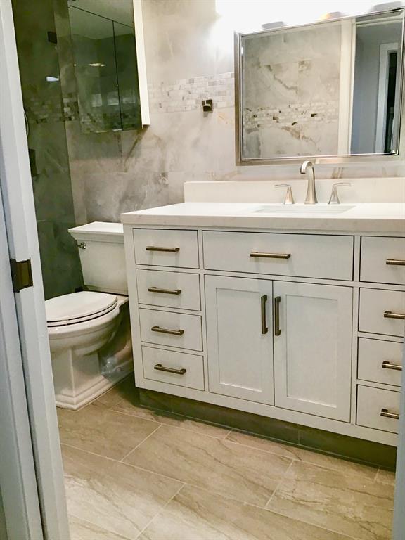 1004 Newcastle A, Unit 1004 Boca Raton, FL 33434 - Photo 8 of 39 a bathroom with a sink toilet and mirror