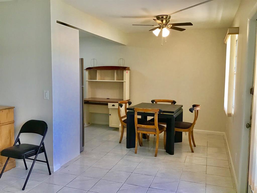 1004 Newcastle A, Unit 1004 Boca Raton, FL 33434 - Photo 10 of 39 a dining room with furniture and chandelier