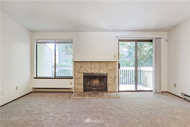 an empty room with furniture and a fireplace