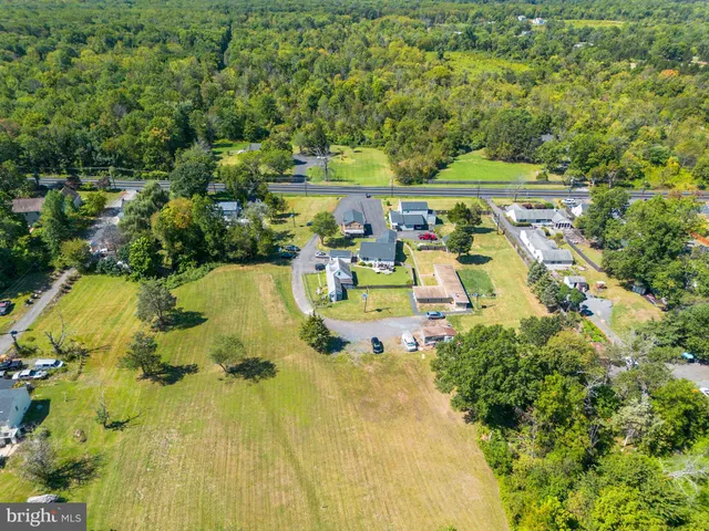 an aerial view of a swimming pool with a yard